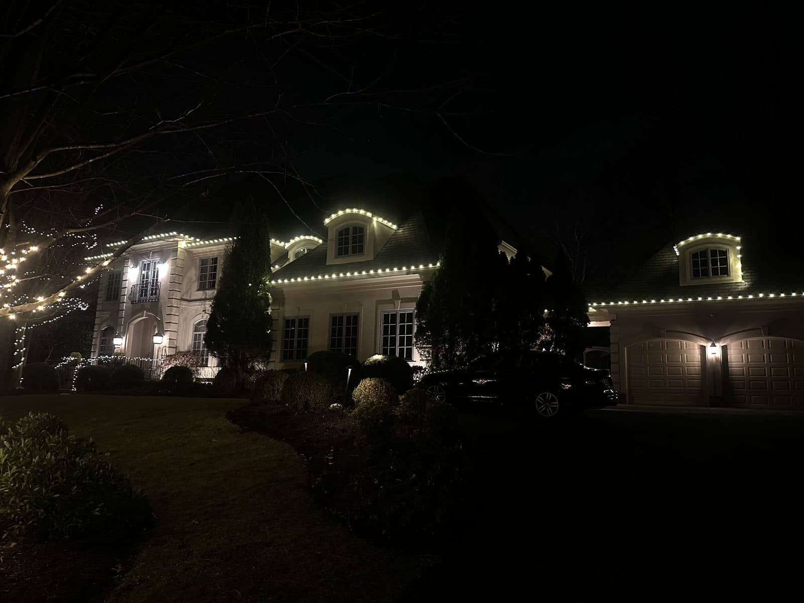 Professional holiday lighting on a DMV home by Light DMV, warm-white roofline display