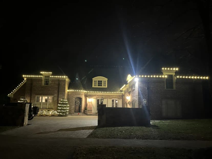 Warm-white C9 roofline on a large brick Potomac colonial estate — LightDMV