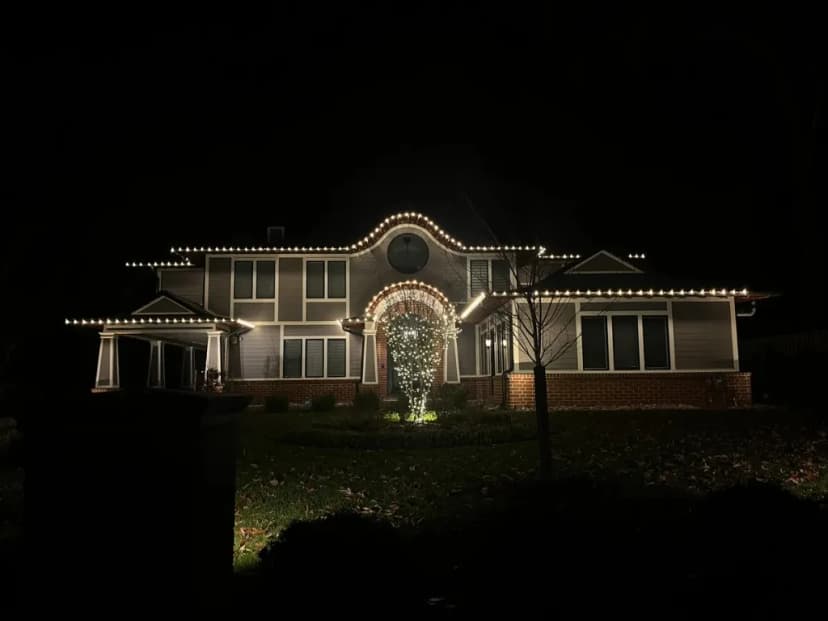 Christmas light installation in the DMV — warm white roofline on a large two-story home