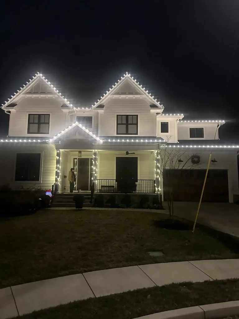 Christmas light installation in the DMV — bright warm white roofline lighting