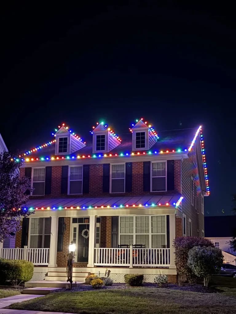 Christmas light installation in the DMV — colorful C9 roofline on a brick home
