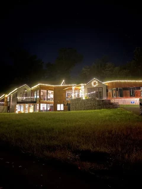 Christmas light installation in the DMV — warm white roofline and landscape accents