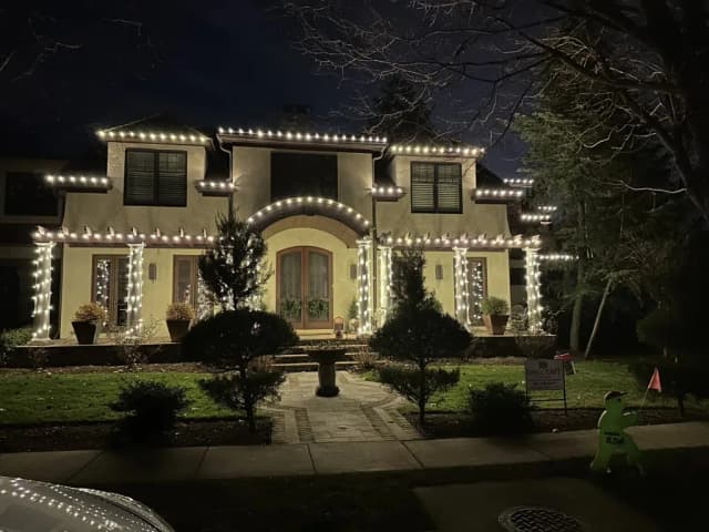 Christmas light installation in the DMV — icicle and roofline lighting in snow