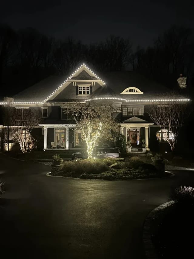 Christmas light installation in the DMV — bright warm white holiday lights on a symmetrical home