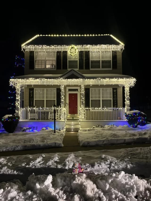 Christmas light installation in the DMV — warm white roofline and landscape lights