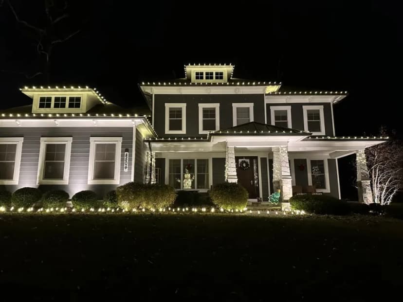 Christmas light installation in the DMV — warm white roofline on a two-story custom home