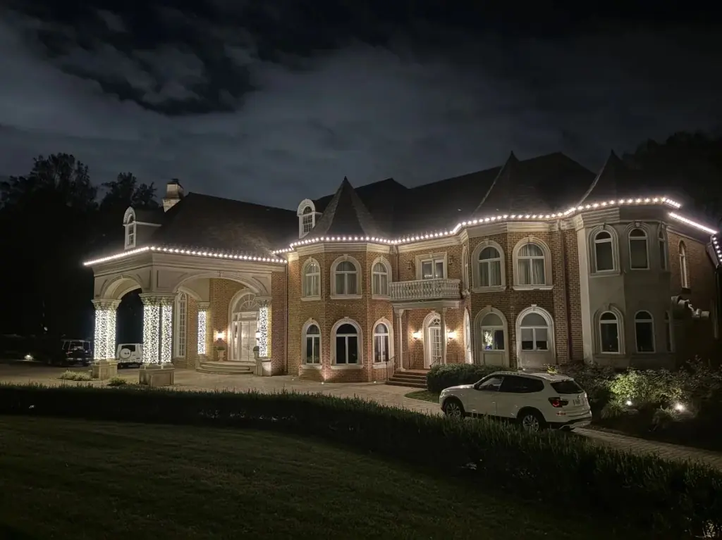DMV estate at night with professional warm white roofline holiday lighting installed by Light DMV