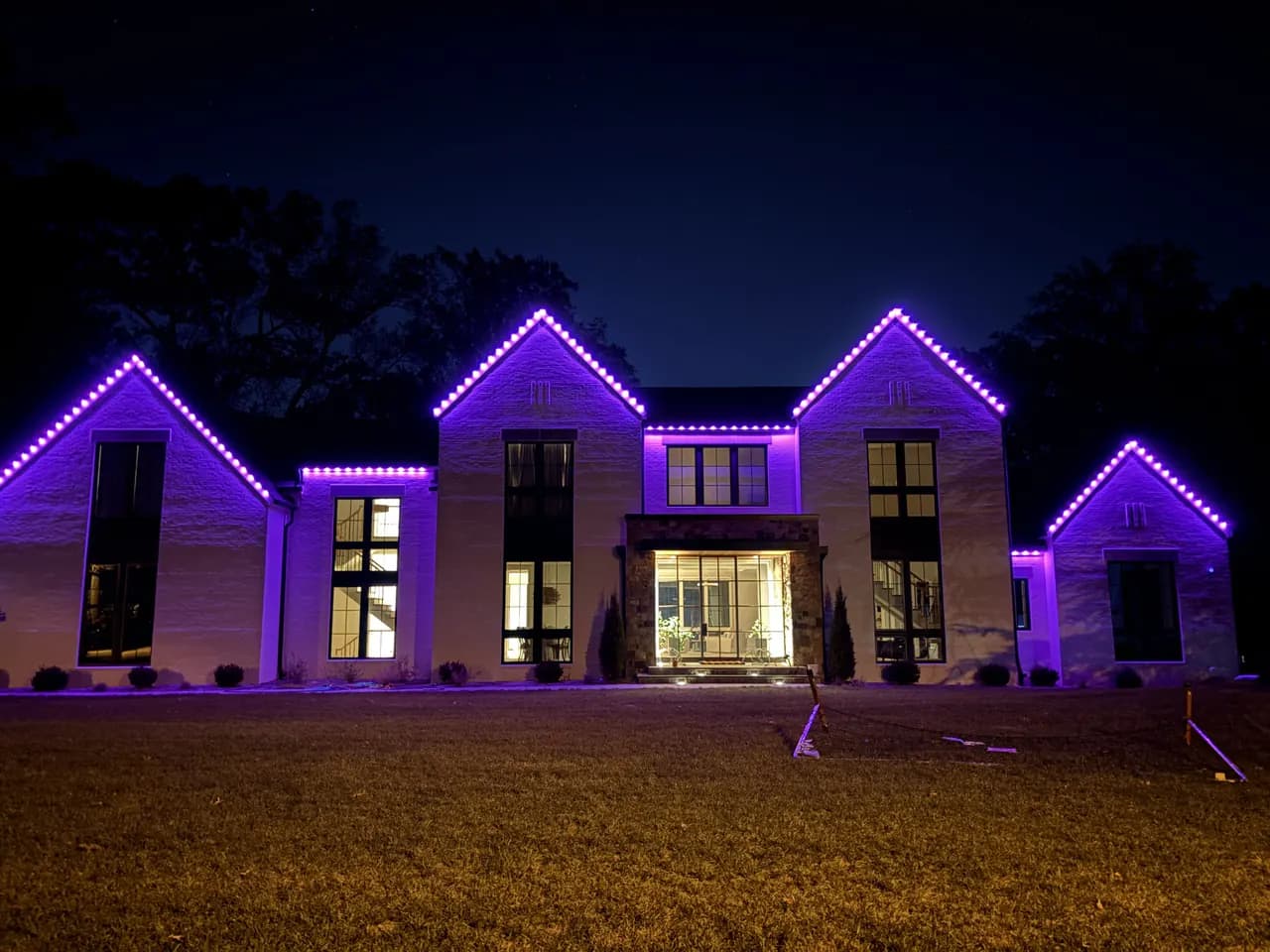 Permanent LED roofline lighting on a Vienna, VA home — custom purple scene at night