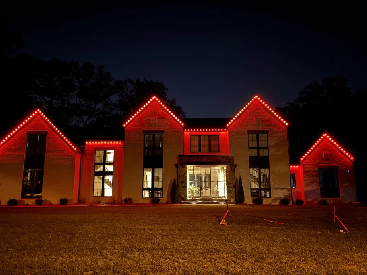 Permanent LED roofline lighting on a Vienna, VA home — game-day red at night