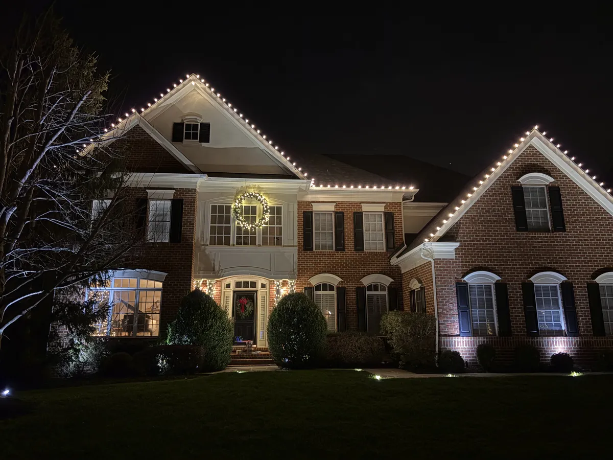 Holiday light installation in Loudoun County, VA by Light DMV — Leesburg-area brick estate, warm-white C9