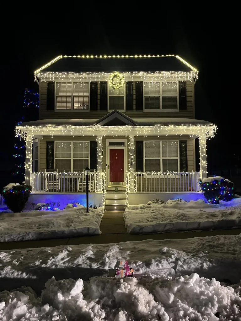 Christmas light installation in the DMV — warm white roofline and landscape lights