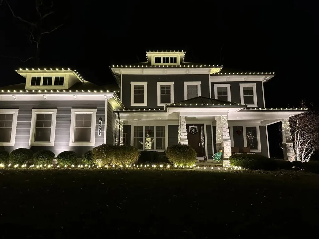 Christmas light installation in the DMV — warm white roofline on a two-story custom home